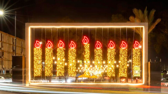 Гигантские светящиеся меноры Хануки украшают город